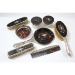 A George V silver and simulated tortoiseshell-backed eight-piece and part dressing table set