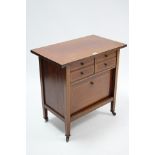 An Edwardian inlaid-mahogany dwarf side cabinet fitted two ranks of two small drawers above a fall-