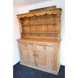 A Victorian-style pine kitchen dresser, the upper part fitted two open shelves and with baluster-