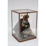 A Vintage pedlar doll in glazed case, case 8¾” wide x 12½” high.
