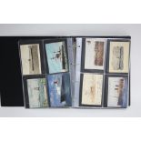 AN ALBUM OF APPROXIMATELY TWO HUNDRED & SIXTY POSTCARDS, EARLY-MID 20th CENTURY, SHIPPING, MILITARY,