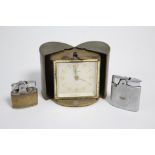 A Europa 7 Jewel travelling alarm clock in brass oval case with raised floral design, 2½” high;