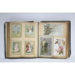 Approximately two hundred various greetings cards contained in a scrapbook, circa late 19th