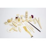 A pair of ivory glove stretchers; a carved ivory sewing clamp; a carved ivory pin cushion; & various