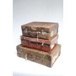 A tan leather suitcase fitted chrome twin-lever locks, 17¾” wide; together with two other suitcases;