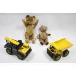 Two golden plush teddy bears (one worn); & two large Tonka Toy Construction models.