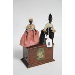 An American automaton in the form of two dancing figures mounted on a wooden rectangular base, 5¾”