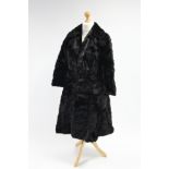 A black rabbit fur silk-lined ladies’ three-quarter length coat.