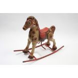 A mid-20th century Mobo? lithographed tinplate child’s rocking horse, 29” high x 26” long.