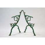 A pair of green painted cast-iron garden bench end supports, 32½” high.