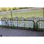 A set of three black painted wrought-iron garden gates of scroll design, each gate 48½” wide x