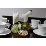 Three glass paperweights; a modern “cow” creamer; a glass fruit bowl; a white glazed part coffee