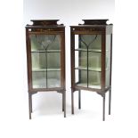 A pair of Edwardian inlaid-mahogany china display cabinets with painted scroll & floral