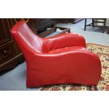 A RED LEATHER LOGE ARMCHAIR & STOOL AFTER A DESIGN BY VAN DEN BERG (slight faults).