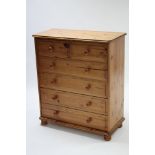 A pine chest fitted two short & four long drawers with turned knob handles, & on turned feet (slight