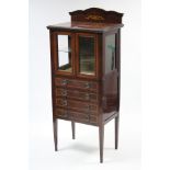 A late 19th/early 20th century inlaid-mahogany music cabinet fitted plate-glass shelf enclosed by