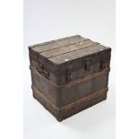 A late 19th/early 20th century fibre-covered & iron bound travelling trunk with fitted interior