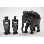 A large carved ebony elephant ornament, 8¾” high; together with two small cloisonné vases each