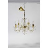 A pair of brass-finish five-branch ceiling light fittings hung with prism drops & with strands of