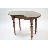 A pine kidney-shaped dressing table on turned tapered legs, 42” wide, complete with drapes.