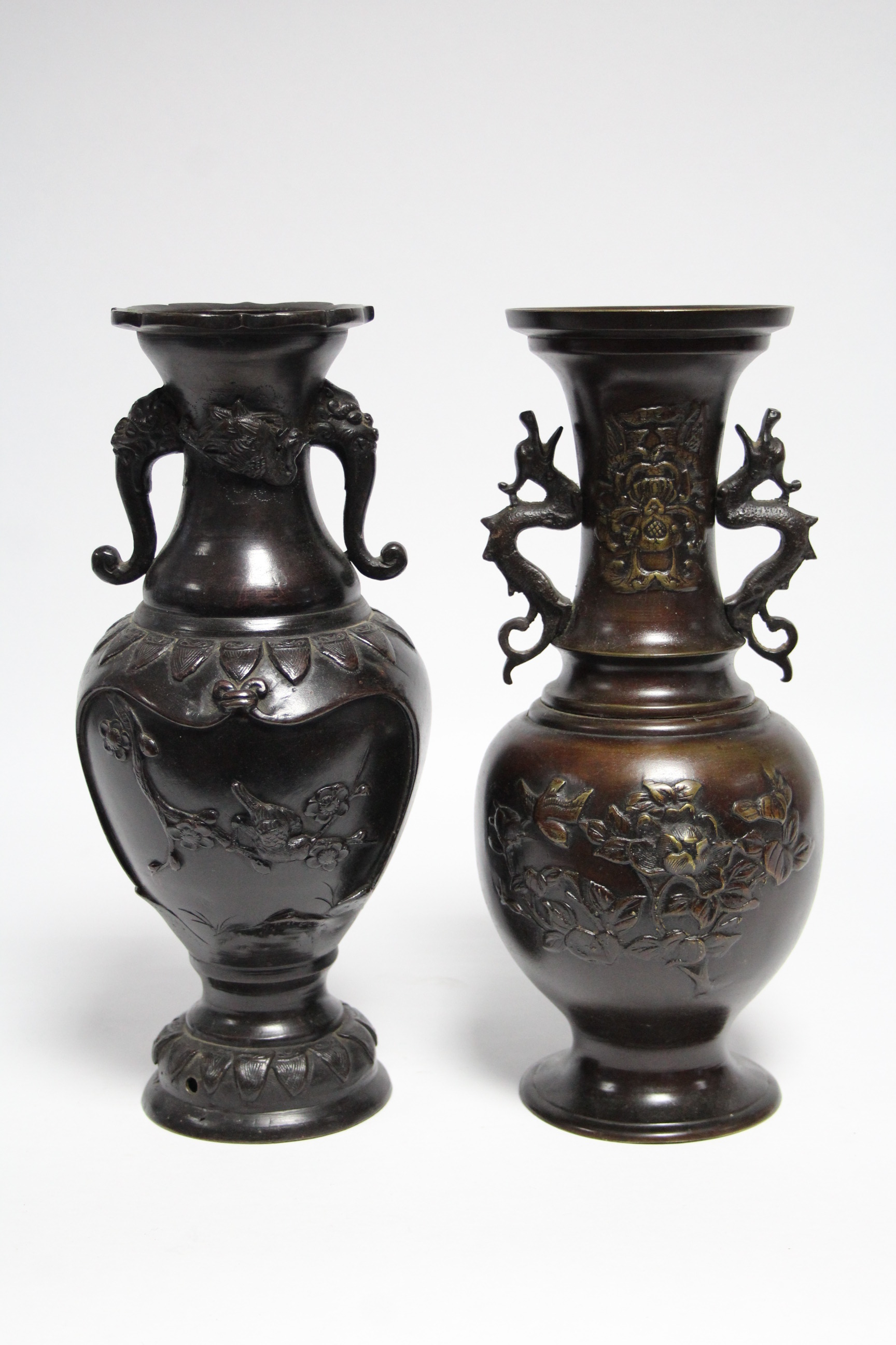 A 19th century Japanese bronze ovoid vase with grotesque mask side handles & raised decoration of