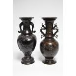 A 19th century Japanese bronze ovoid vase with grotesque mask side handles & raised decoration of