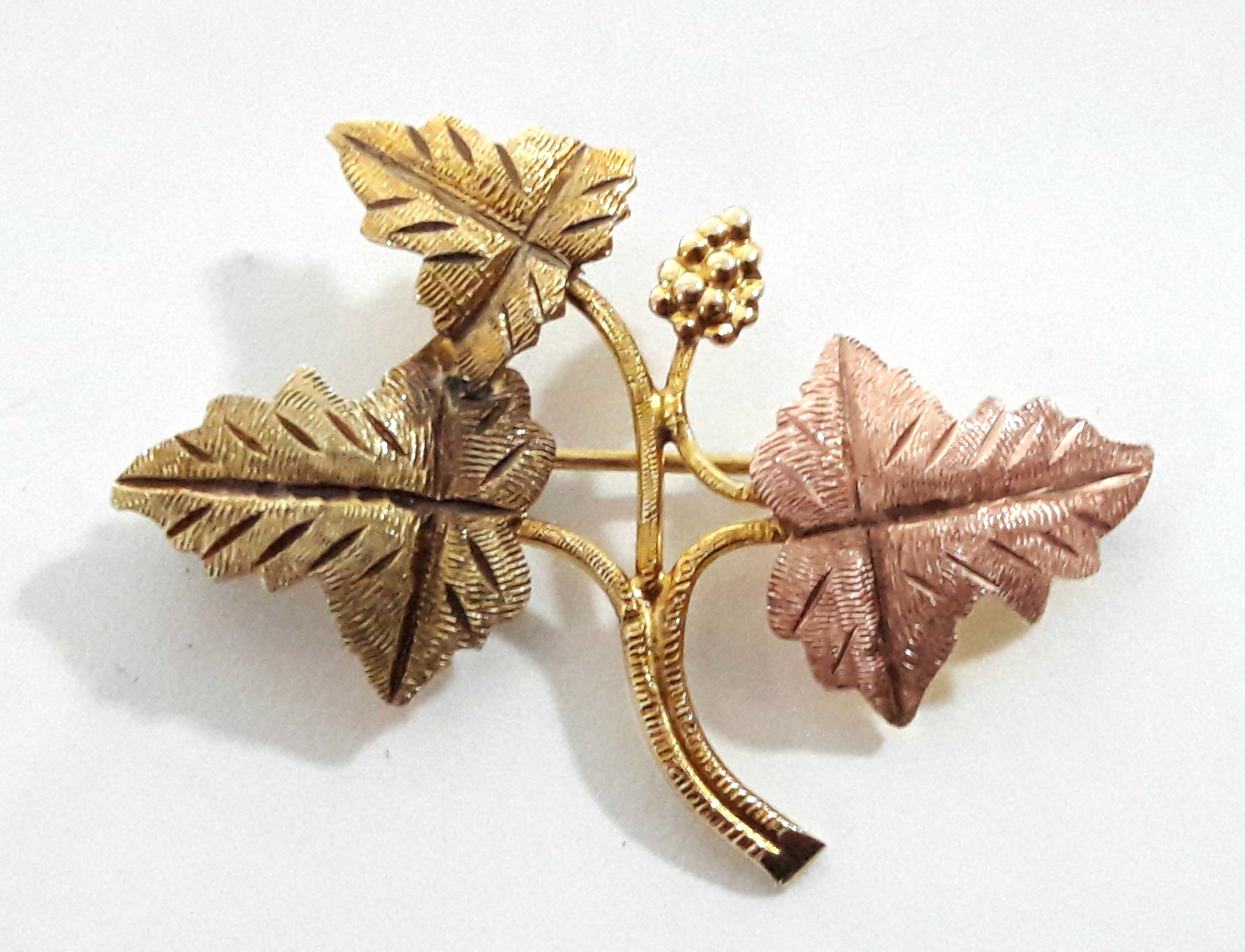 An un-marked three-colour yellow metal leaf spray brooch.