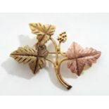 An un-marked three-colour yellow metal leaf spray brooch.