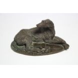 WAUGH, Elizabeth (born 1929). A bronze model of a recumbent deerhound, on oval "flag stone" base, 9"
