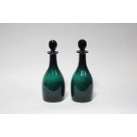 A PAIR OF GEORGIAN EMERALD GLASS DECANTERS, each of mallet shape, with flat-sided oval stopper;