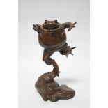 A contemporary bronze sculpture of a leaping toad by Joan Shingleton, titled: “Floating Balance”,