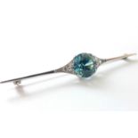 An Art Deco white metal knife-edge bar brooch set large blue zircon of approx. 4 carats, a trio of