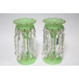 A pair of mid-19th century green opaque glass candle lustres hung with clear prism drops; 8¾” high.