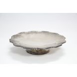 A round shallow dish with shaped reeded rim, on low circular pedestal foot, 7” diam. x 1¼” high;