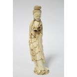 A Chinese carved ivory standing figure of Guan Yin holding a willow branch in her left hand, a