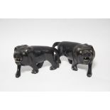 A pair of African carved ebony models of roaring lions; 6½” long.