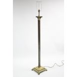 A brass standard lamp with fluted Corinthian column, on square base with lion-paw feet; 55” high.