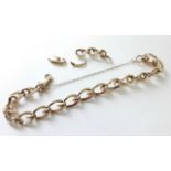 A 9ct. gold curb-link bracelet with safety chain; three further loose links of same design, & a