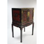 AN 18th century or earlier CHINESE LACQUER CABINET enclosed by a pair of panel doors, decorated