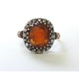 AN EARLY 19th century GARNET CAMEO RING, the oval stone carved in relief with a classical female