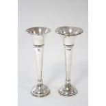 A pair of trumpet shaped spill vases, each on round domed foot, 9” high; London 1918/19, by J. E. (