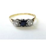 An 18ct. gold ring set square sapphire, flanked by a brilliant-cut diamond either side, each approx.