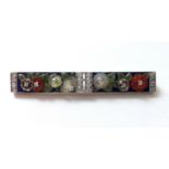 AN ART DECO MULTI-GEM BAR BROOCH designed as flower-heads & leaves carved of various coloured