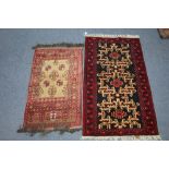 A Persian rug of dark blue ground, with cream hook pattern within crimson border, 60" x 35"; & a