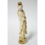 A Chinese carved ivory standing figure of Guan Yin pouring water from a flask held in her right