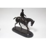 BONHEUR (after). A bronze sculpture of a racehorse with jockey up; 14” high x 14” wide.