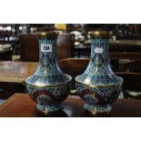 A pair of Chinese cloisonné baluster vases decorated with dragons & stylised flowers on a