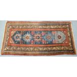 A Hamadan rug of blue ground with row of five geometric panels in pale blue & pink, within