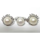 A pair of 14K white gold earrings, each set large pearl & numerous small round & baguette