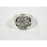 A DIAMOND CLUSTER RING, the centre stone approx. 0.5 carat, set within a border of eight smaller